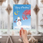 Tarjeta Festiva Un hombre de nieve con cara a la luna<br><div class="desc">Hombre de nieve lindo encima de un montículo de montones de nieve. Agarrando a su gorra y mitones mirando hacia la luna de oro y las estrellas. Blue Sky y Red Swirly Branch Candy Cane Tree hacen que esta Feliz Navidad y Feliz Año Nuevo la tarjeta de felicitación sea simplemente...</div>