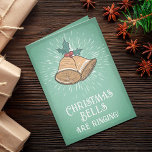 Tarjeta Festiva Vintage Christmas Bells Holiday Card<br><div class="desc">Esta elegante y vintage tarjeta de felicitación navideña es perfecta para las vacaciones. Presenta campanas de Navidades dibujadas a mano, bayas huecas, hojas de hiedra y papel vintage. Los colores son verde retro, blanco, tostado dorado, rojo y verde verde azulado. Es un recuerdo de un momento mejor y seguro que...</div>