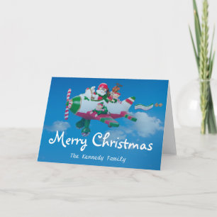 Tarjeta Festiva Volando Santa Claus con elfos en avión