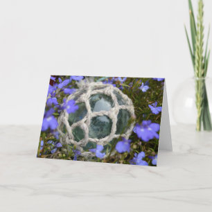 Tarjeta Flotador pesquero entre flores