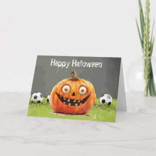 Tarjeta Fútbol Feliz Halloween con bolas sobre hierba verd