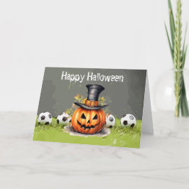 Tarjeta Fútbol Feliz Halloween con bolas sobre hierba verd
