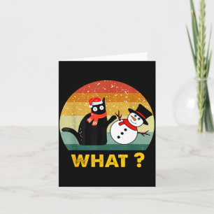 Tarjeta Gato negro divertido empujando un muñeco de nieve