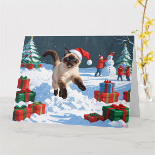 Tarjeta Gato siamés corriendo en la nieve con sombrero de 