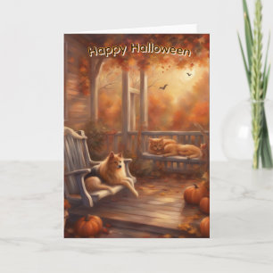 Tarjeta Gato y perro felices de Halloween en un porche del