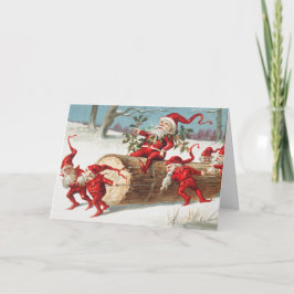 Tarjeta Gnomes dragging a cut tree trunk through the snow