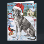 Tarjeta Greyhound Winter Navidades Wonderland Alegría<br><div class="desc">Este diseño festivo capta el alegre espíritu de la temporada navideña, con un adorable cachorro vestido con un sombrero de Santa. El perro está enclavado en un maravilloso país invernal, con un muñeco de nieve, un árbol de Navidad decorado y regalos hermosamente envueltos. Los copos de nieve caen suavemente, añadiendo...</div>