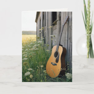 Tarjeta Guitarra de cumpleaños apoyada en un granero rural