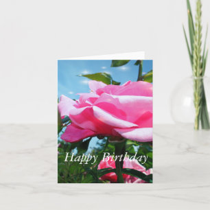 Tarjeta Hermosa flor de rosa rosa y hojas verdes en azul