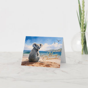 Tarjeta Koala en una playa de arena Feliz Navidad
