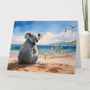 Tarjeta Koala en una playa de arena Feliz Navidad
