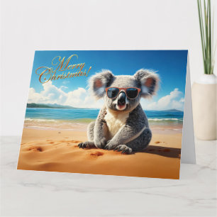 Tarjeta Koala en una playa de arena Feliz Navidad