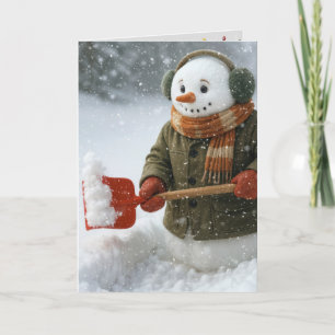 Tarjeta Muñeco de nieve de Navidad paleando nieve