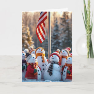 Tarjeta Muñecos de nieve festivos mirando hacia la bandera