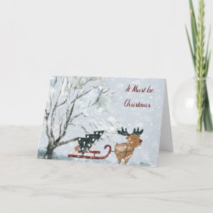 Tarjeta Navidades con alce tocando el árbol de Navidad