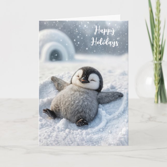 Tarjeta Navidades de pingüino haciendo un ángel de nieve (Anverso)