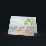 Tarjeta Navidades únicos de Beach Flamingo Wreath<br><div class="desc">Feliz Navidad en esta preciosa playa de Watercolor - escena tranquila y suave con dos tumbonas - flamencos amistosos con una hermosa corona - Palmera con algunos adornos. También disponible en diferentes pesos de papel: su selección. Cualquier pregunta de diseño, sólo envíe un correo electrónico a charmdesignstudio@rcn.com y estaremos encantados...</div>