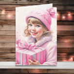 Tarjeta Niña pequeña y linda en Navidades retro rosado<br><div class="desc">tarjeta de vacaciones para Navidades de acuarela de bonito. Pequeño y adorable chica vintage con gorro de invierno,  con una caja de regalo retro de color rosa.</div>