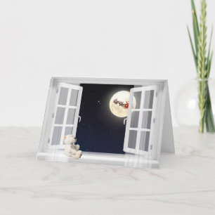 Tarjeta oso de peluche en la ventana con luna de Navidad