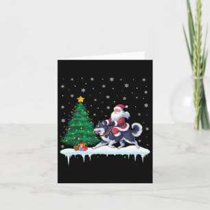 Tarjeta Papá Noel montando un perro Klee Kai de Alaska niñ