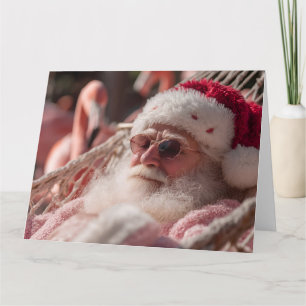 Tarjeta Papá Noel relajándose en hamaca con gafas de sol