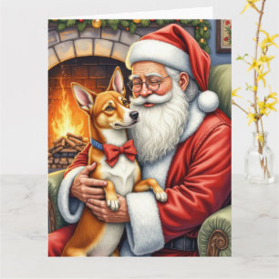 Tarjeta Papá Noel sosteniendo arte navideño de Basenji