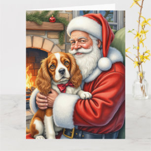 Tarjeta Papá Noel sosteniendo un Cavalier King Charles Spa
