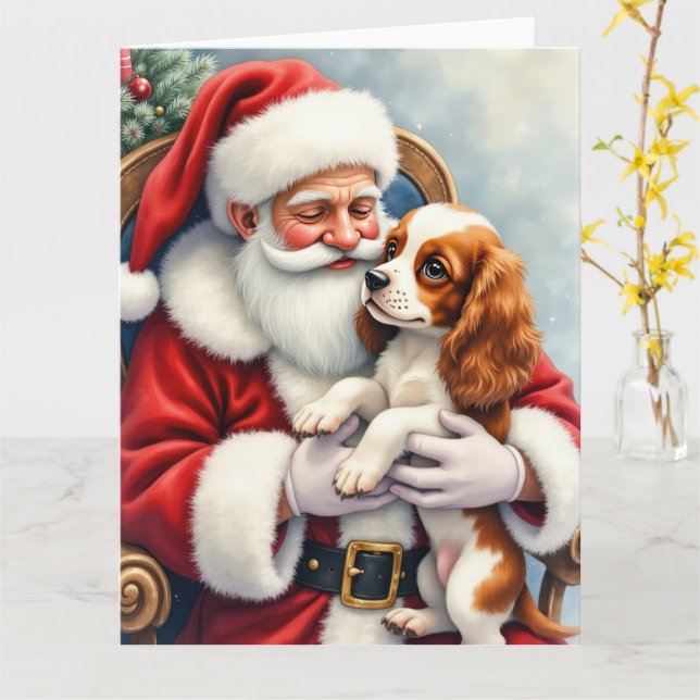 Tarjeta Papá Noel sosteniendo un Cavalier King Charles Spa (flor amarilla)