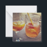 Tarjeta Pequeña Sangria and Sunshine<br><div class="desc">This image shows a refreshing glass and pitcher of citrus sangria, perfect for a warm day. The fresh slices of lemon and orange add bright colour and hint of natural sweetness. One glass sits ready to enjoy while sangria is being poured from a small glass pitcher beside it, perfect for...</div>