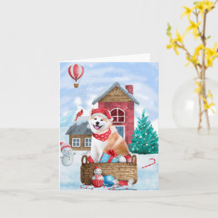 Tarjeta Perro Akita en casa de Navidad con nieve