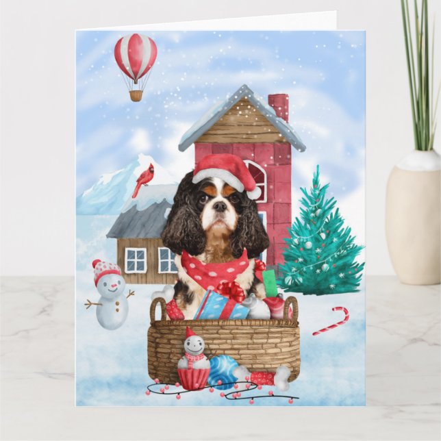 Tarjeta Perro King Cavalier en casa de Navidad con nieve (Anverso)