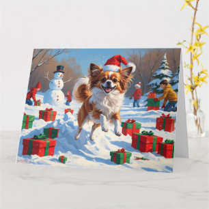 Tarjeta Perro Papillon corriendo en la nieve con sombrero 