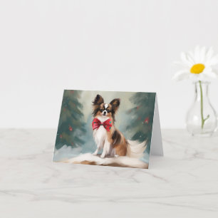 Tarjeta Perro Papillon en Navidades de nieve