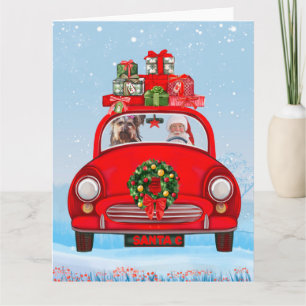 Tarjeta Perro Terrier de Yorkshire en coche con Papá Noel