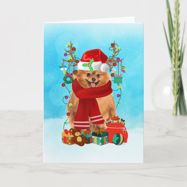 Tarjeta Pomerania en la nieve con regalos de Navidades (Anverso)