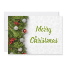 Ramas verdes y ornamentos de Feliz Navidad