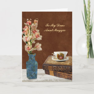 Tarjeta Ramo de orquídeas con libros y taza Cumpleaños