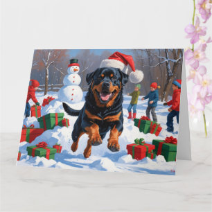 Tarjeta Rottweiler corriendo en la nieve con sombrero de N