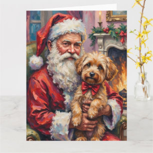 Tarjeta Santa Claus sosteniendo arte navideño de Yorkipoo