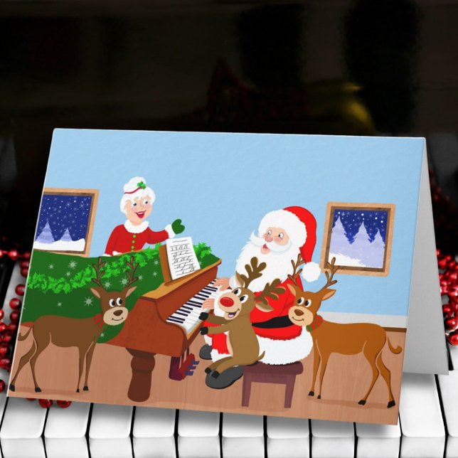 Tarjeta Santa tocando el piano con manta de renos  (Subido por el creador)