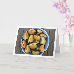 Tarjeta Tazón de frutos de ciruela cortada en mesa de made