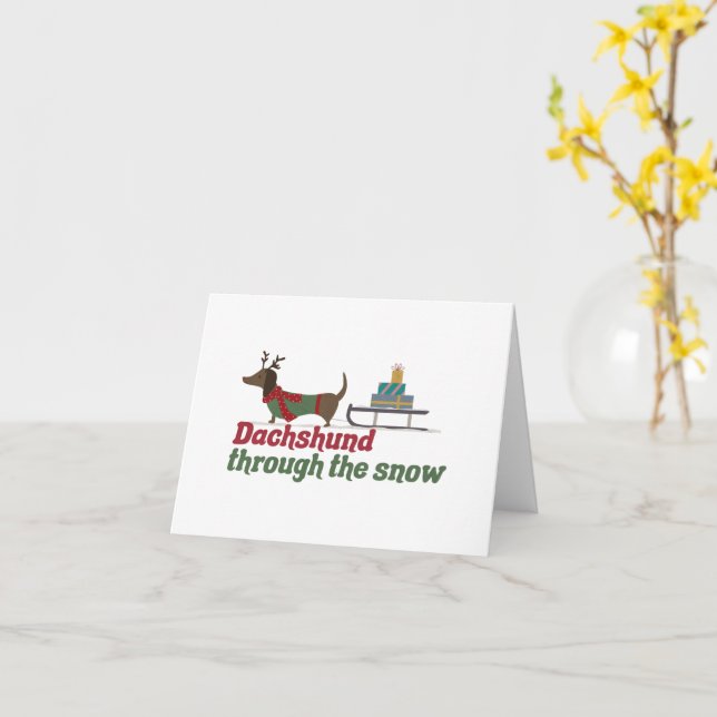 Tarjeta Un perro navidad: Dachshund a través de la nieve (flor amarilla)