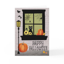 Ventana de Halloween con gato negro y calabazas