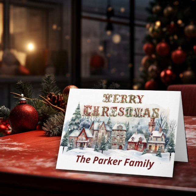 Tarjeta Victoria Village Merry Christmas (A Christmas card stands on top of a table with Christmas elements in the background.)