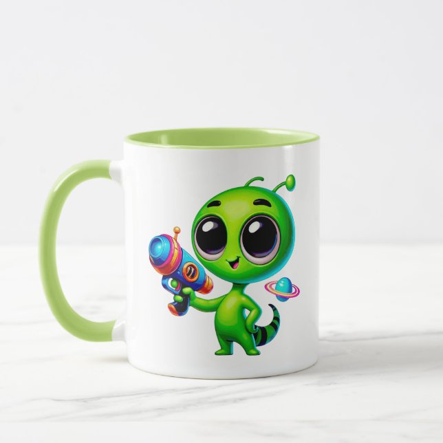 Taza Alien mignon avec un pistolet laser et une planète (Izquierda)