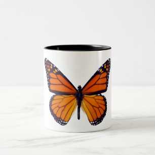 Taza anaranjada de la mariposa