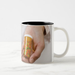 Taza Bicolor Farmacéutico que sostiene las botellas de píldor