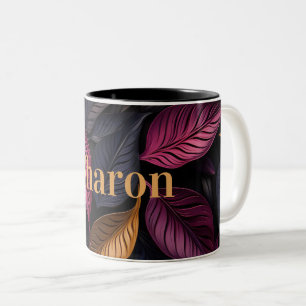 Taza Bicolor patrón elegante de hojas oscuras con nombre dorado