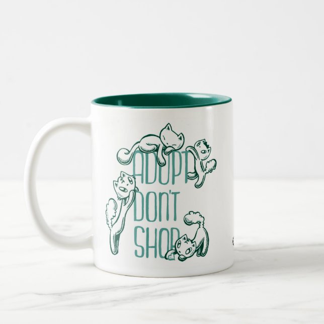 Taza Bicolor Todos los gatos: Adopt no hace compras (Izquierda)