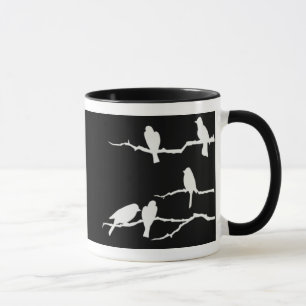 Taza blanca de la silueta del pájaro